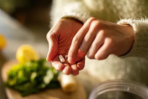 Person taking vitamins and supplements